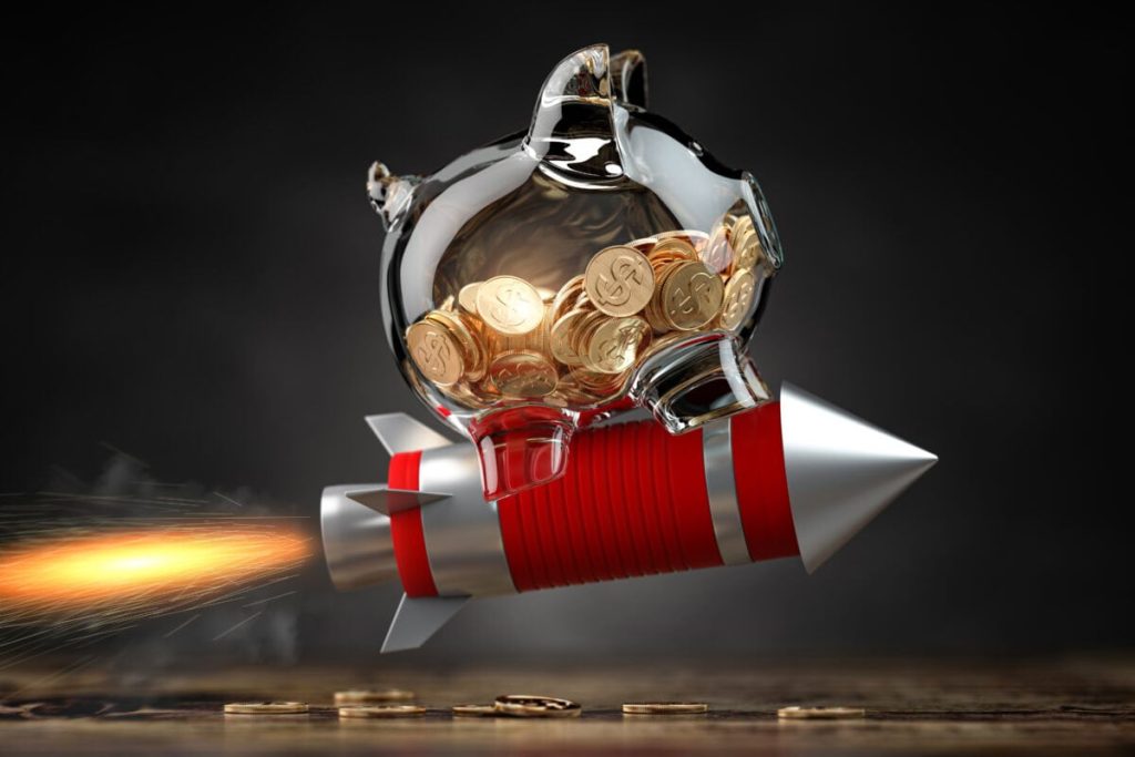 Piggy bank on a flying rocket